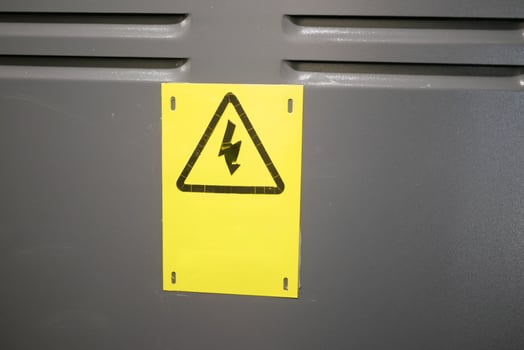 The triangular yellow sign of the danger of electric shock photo