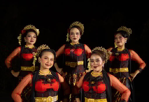 a group of dancers stand tall as red costumes provide a dramatic and graceful contrast photo