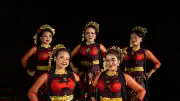 a group of dancers stand tall as red costumes provide a dramatic and graceful contrast photo