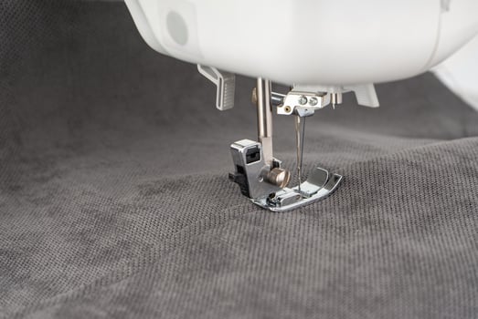 Modern sewing machine with gray fabric photo