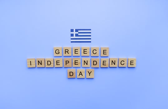 March 25, Independence Day in Greece, the flag of Greece, a minimalistic banner with an inscription in wooden letters photo
