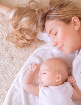 Newborn child sleeping with mom photo