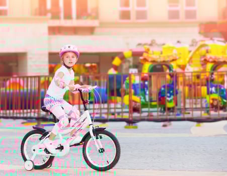 Happy little girl on the bicycle photo