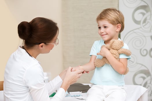Happy boy visiting doctor photo