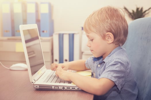 Little boy working on the laptop photo
