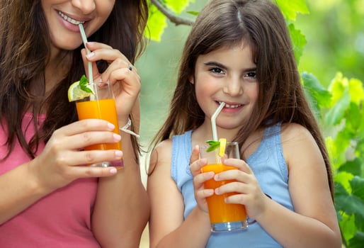 Mother with daughter enjoying juice photo