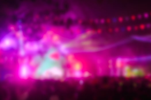 Blurred image people enjoying watching concert an outdoors music at night. photo