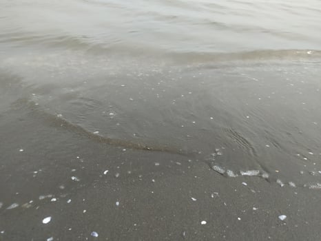 small waves of murky sea water photo
