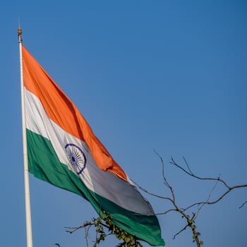 India flag flying high at Connaught Place with pride in blue sky, India flag fluttering, Indian Flag on Independence Day and Republic Day of India, tilt up shot, Waving Indian flag, Har Ghar Tiranga photo