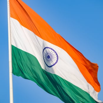 India flag flying high at Connaught Place with pride in blue sky, India flag fluttering, Indian Flag on Independence Day and Republic Day of India, tilt up shot, Waving Indian flag, Har Ghar Tiranga photo