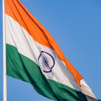 India flag flying high at Connaught Place with pride in blue sky, India flag fluttering, Indian Flag on Independence Day and Republic Day of India, tilt up shot, Waving Indian flag, Har Ghar Tiranga photo