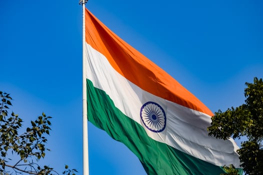 India flag flying high at Connaught Place with pride in blue sky, India flag fluttering, Indian Flag on Independence Day and Republic Day of India, tilt up shot, Waving Indian flag, Har Ghar Tiranga photo