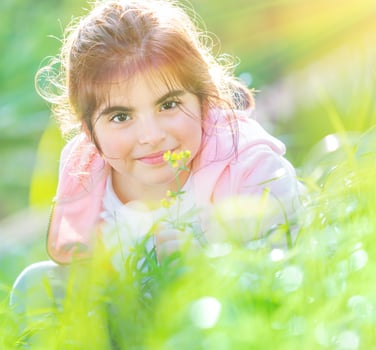 Baby girl enjoying flowers photo