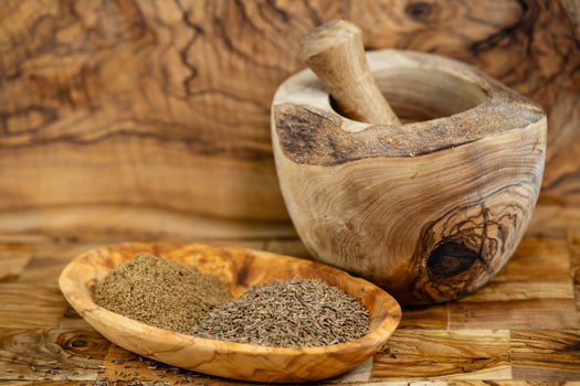 caraway seeds Carum carvi on olive wood photo