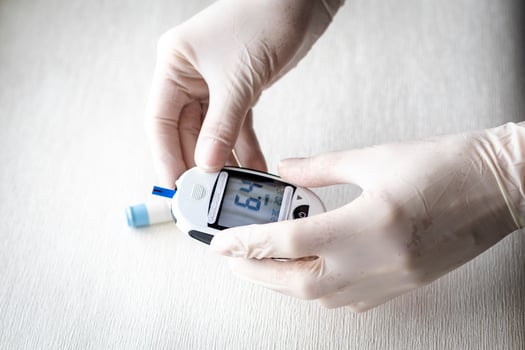 Close up shot of the nurse holding glucometer instrument. Healthcare photo