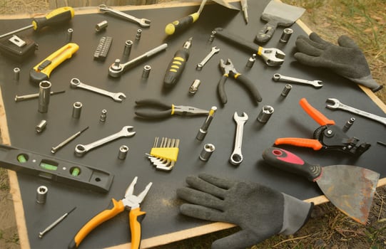 Handyman tool kit on black wooden table. Many wrenches and screwdrivers, pilers and other tools for any types of repair or construction works. Repairman tools photo