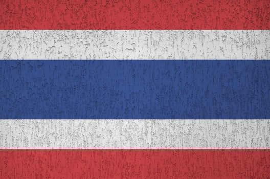 Thailand flag depicted in bright paint colors on old relief plastering wall. Textured banner on rough background photo