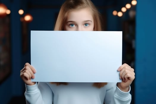 AI generated Cute little girl holding blank white sheet of paper in her hands photo