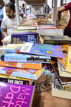 Delhi, India, May 09 2024-Various age group people reading variety of Books on shelf inside a book stall at Delhi photo