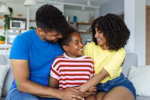 happy family mother father and child daughter laughing and havig fun at home. Happy African American family relaxing photo
