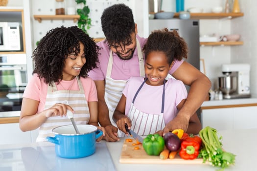 Family with adorable daughters gathered in modern kitchen cooking together.Enjoy communication and cookery hobby concept. photo