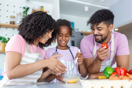 In the Kitchen  Family Cooking Muffins Together. Mother , Father and Daughter Mixing Flour and Eggs to Create Dough for Cupcakes, ,Children Helping Parents photo