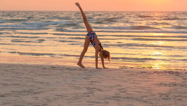 Teen girl having fun on the beach photo