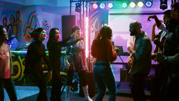 Funky persons doing dance battle to show off electronic music at discotheque, having fun at cool disco party with dancers. Happy people improvising breakdance battle at event. Handheld shot. photo