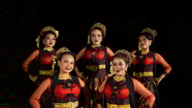 a group of dancers stand tall as red costumes provide a dramatic and graceful contrast photo
