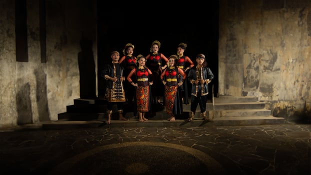 a group of dancers stand tall as red costumes provide a dramatic and graceful contrast photo