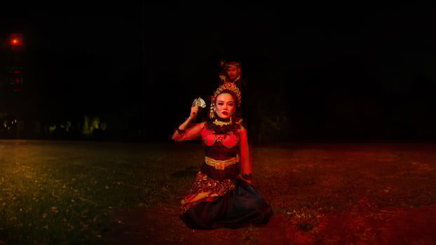 a group of female dancers with faces full of heavy emotional burdens sitting in the dark of night photo