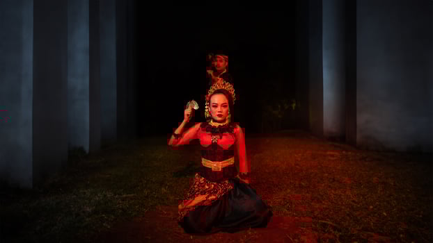 a female dancer in a red costume sat in the silence of the night which strengthened the sadness photo
