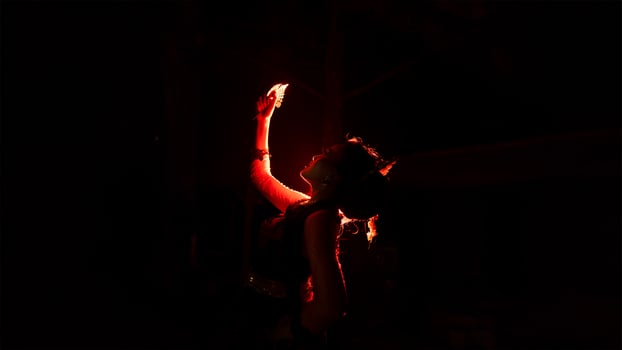 a woman holding gold jewelry with trembling hands and full of worries photo