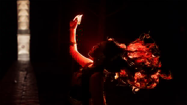 the silhouette of a woman looking at her jewelry with a face full of sadness and the fire burning around her photo