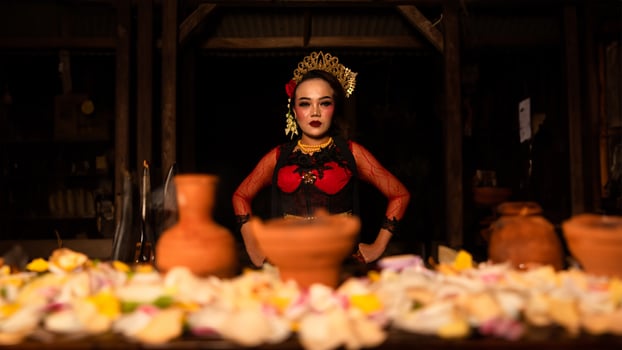 a female dancer sits gracefully and begins her ritual in front of beautiful offerings photo