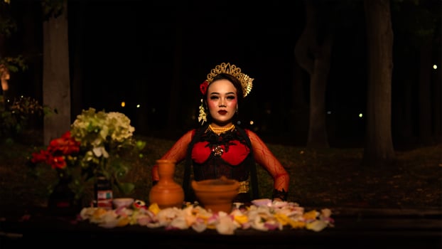 a female dancer who looks beautiful in a red costume performs a ritual that radiates an aura of beauty and purity photo