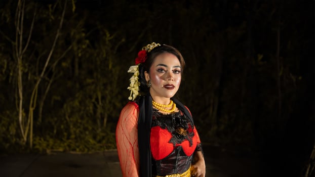 a female dancer in a red dress danced on stage, reflecting the beauty of her movements and adding to the charm of her performance photo