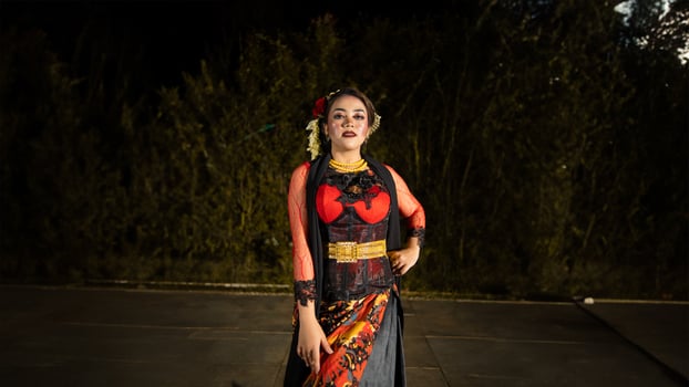a Javanese dancer makes flexible and flowing movements in time with the rhythm of the music photo