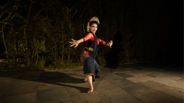 a Balinese dancer wearing a red dress with artistic details that add uniqueness to her appearance photo