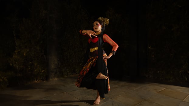A Sundanese dancer wears a beautiful sparkling red costume and dances with a passionate expression photo