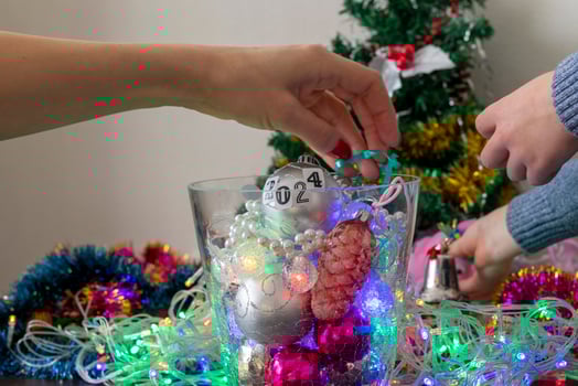 Close up shot of woman and little boy decorating christmas tree. New year changing numbers. Holiday photo