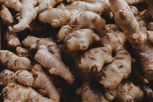 Fresh ginger root on display at a farmers market, close up. photo