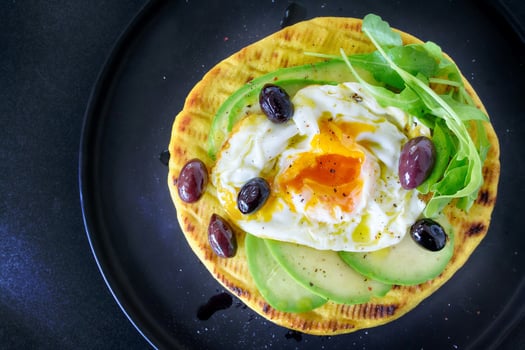 Avocado pancake with fried egg on top. Delicious healthy breakfast. photo
