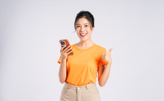 Portrait of cheerful happy Asian woman posing on white background photo