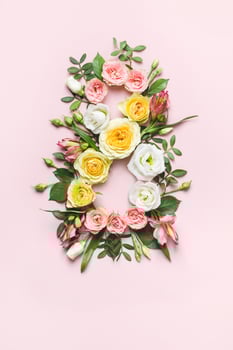 March 8th concept. Creative layout made of colorful rose flowers on pink background. Greeting Card Women's Day on March 8th photo