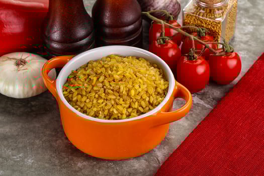 Dry wheat bulgur cereal heap photo