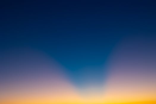 Crespuscular rays on the sky at sunset without clouds photo
