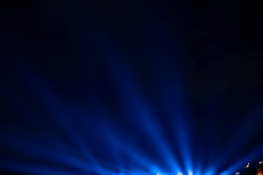 Blue spotlight rays. Projector light rays background photo