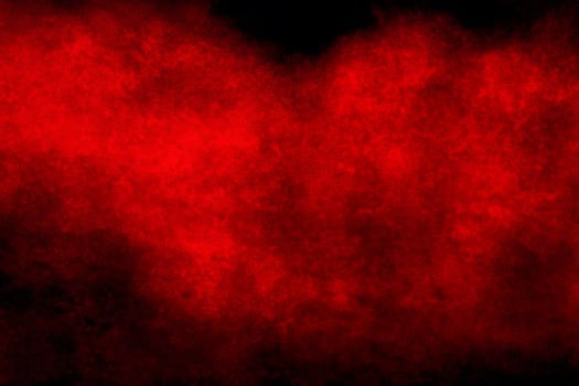Red powder explosion cloud on black background. photo