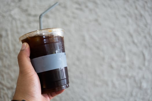 Hand hold a glass of iced americano photo